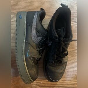 Nike Black Low-Top Sneakers with Blue Swoosh